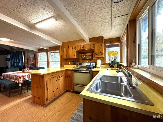 a kitchen that has a sink stove and cabinets