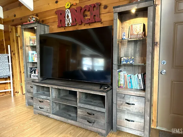 a living room with furniture and flat screen tv