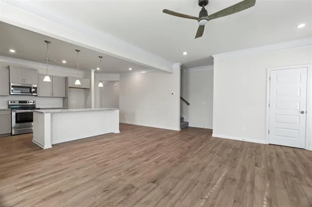 a view of kitchen with refrigerator microwave and stove