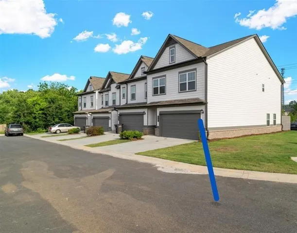 a front view of a house with a garden and yard