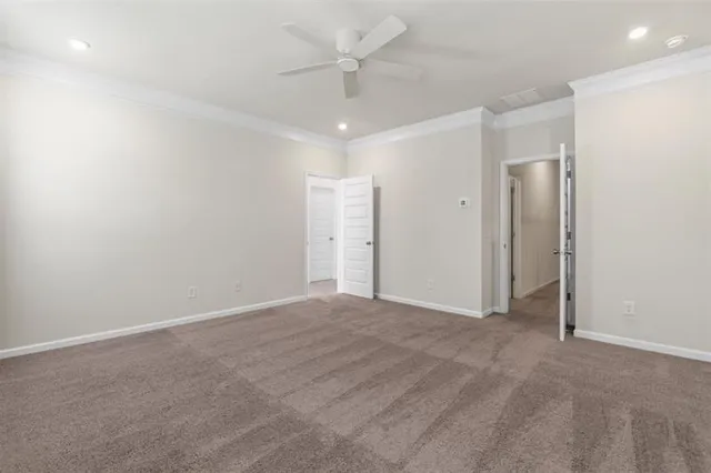 an empty room with fan and entryway