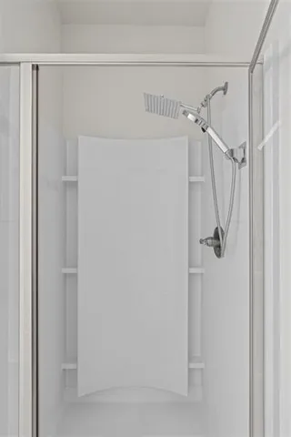 a bathroom with a glass shower door