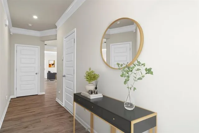 a view of hall way with furniture and wooden floor