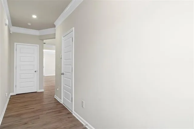 a view of hallway with wooden floor
