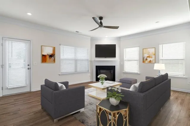 a living room with furniture a fireplace and a flat screen tv