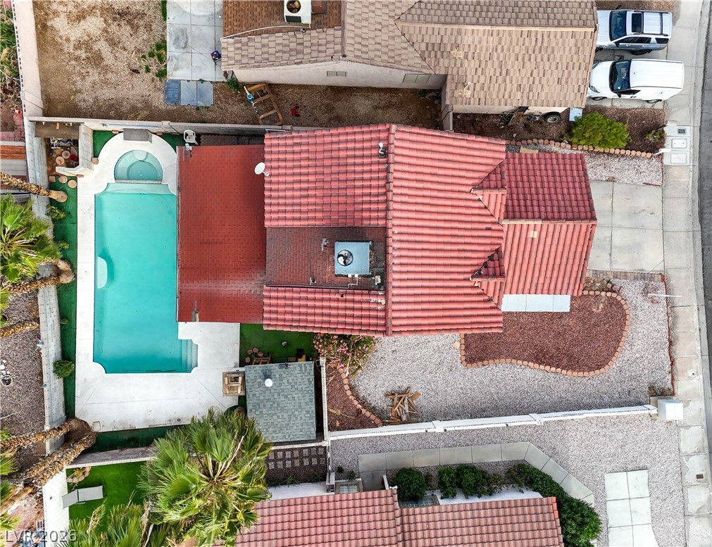 581 Carleton Drive Henderson, NV 89014 - Photo 35 of 37 An aerial perspective showcases a vibrant backyard pool with surrounding desert-friendly landscaping.