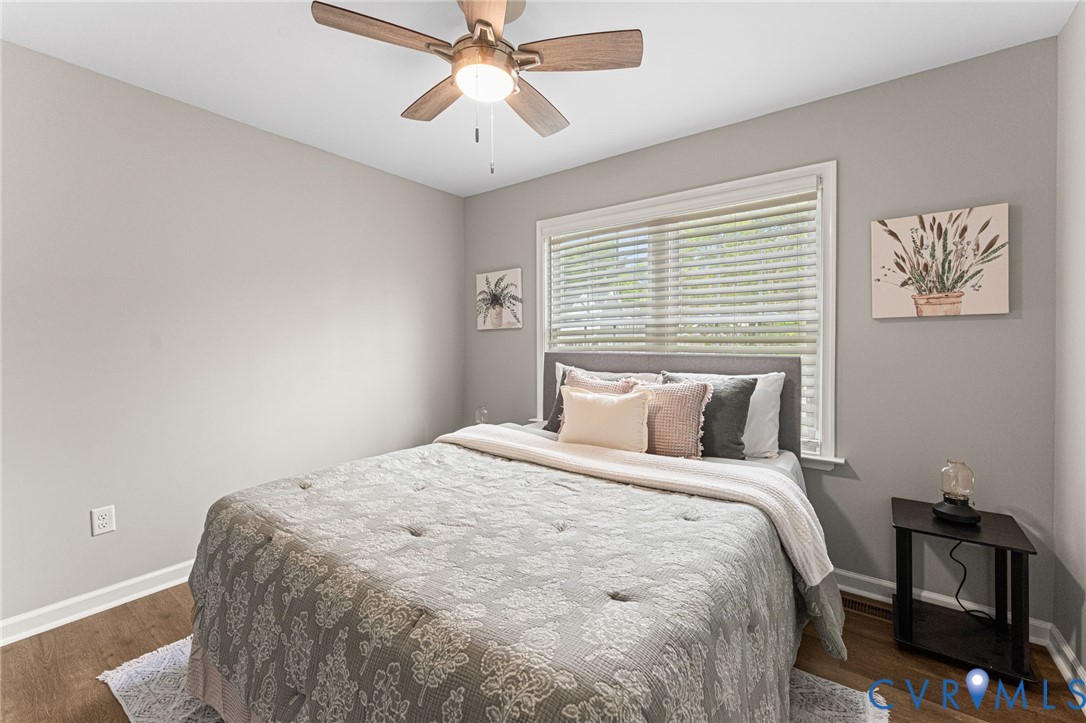 829 Rome Street Petersburg, VA 23803 - Photo 17 of 22 a bedroom with a bed and a chandelier