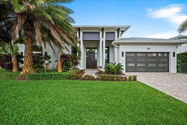 a front view of a house with a yard and porch