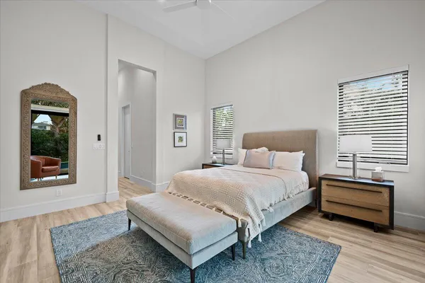 a bedroom with a bed and a large window