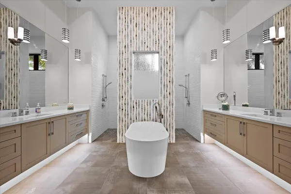 a spacious bathroom with a tub sink and mirror