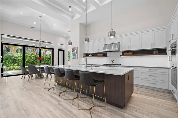 a kitchen with a sink cabinets and wooden floor