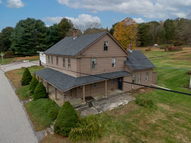 an aerial view of a house with a yard