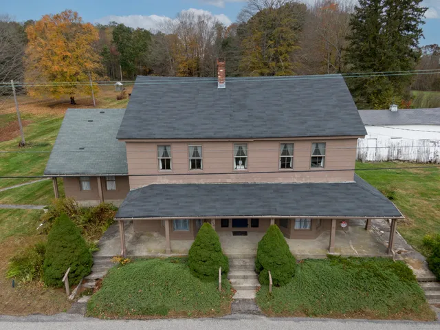 an aerial view of a house with a yard