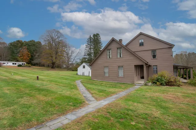 a big house with a big yard and large trees