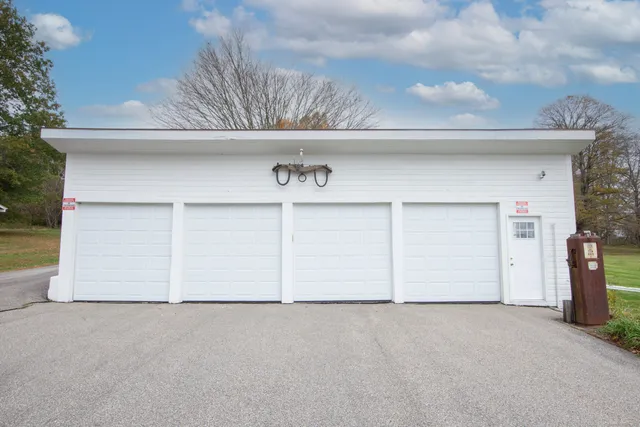 a house view with a garden space and wooden fence