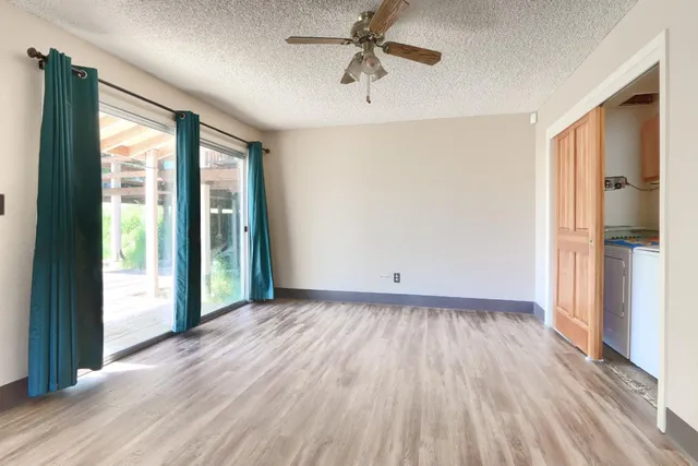 wooden floor in an empty room with a window