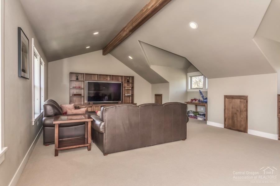 63528 Old Deschutes Road Bend, OR 97701 - Photo 21 of 25 a living room with furniture and a flat screen tv
