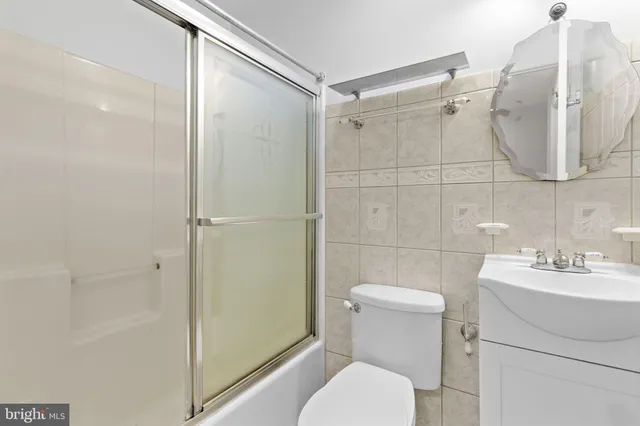 a bathroom with a toilet a sink and shower