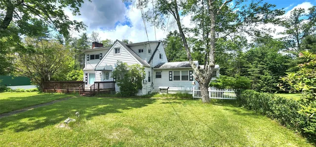 a view of a house with a yard porch and sitting area
