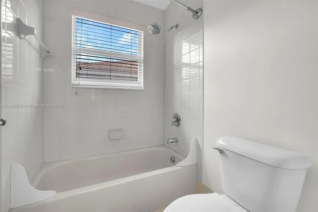a white bath tub sitting next to a toilet