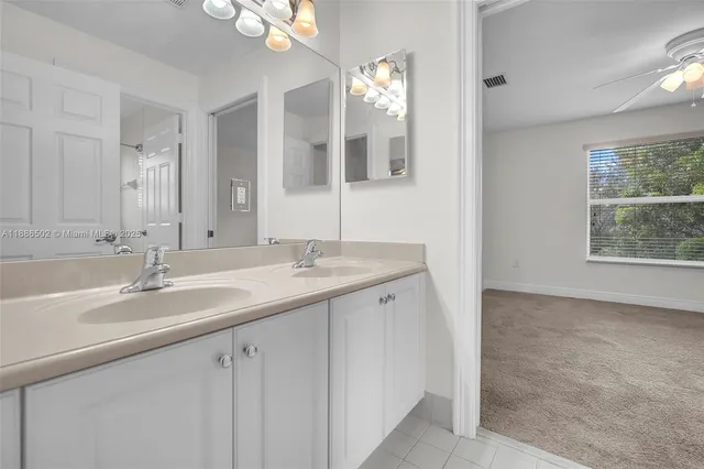 a bathroom with a double vanity sink and a mirror