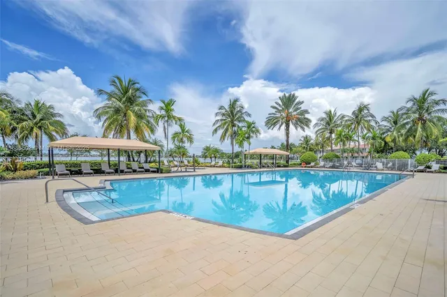 a view of swimming pool with outdoor seating and plants
