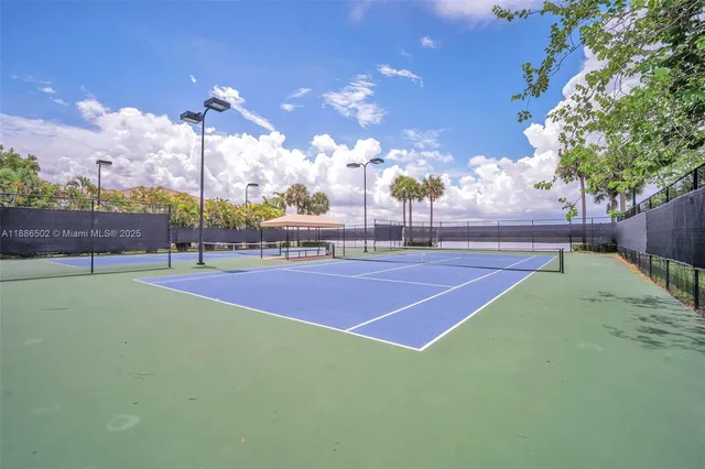a tennis court with view of tall buildings