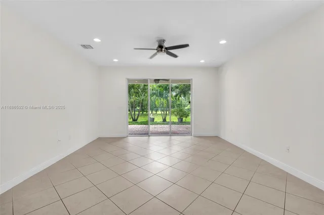 an empty room with windows and outdoor view