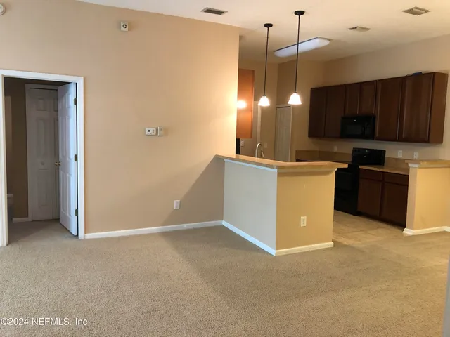 a view of a livingroom with a ceiling fan and window