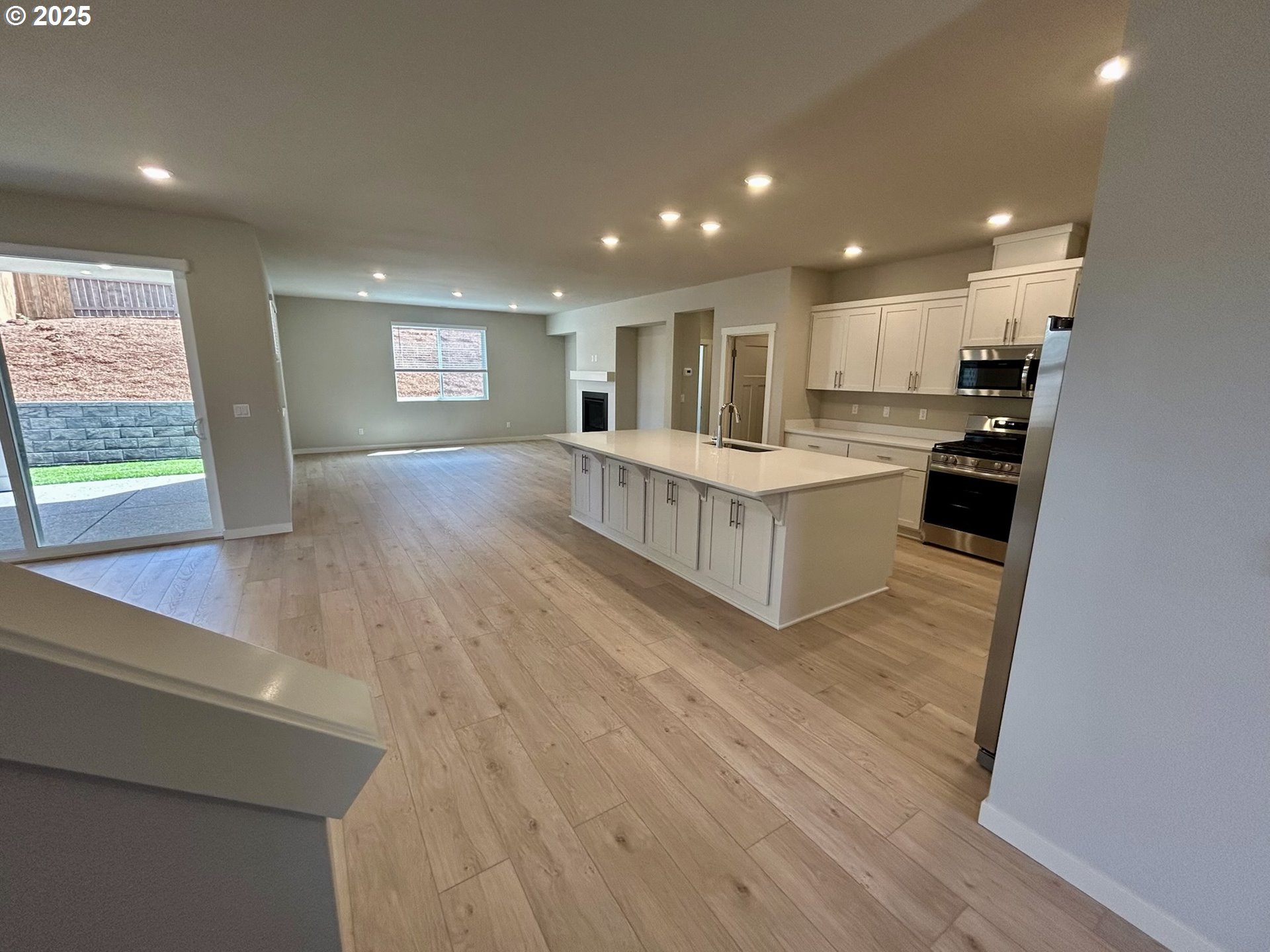 14956 Southwest 165th Avenue Tigard, OR 97224 - Photo 27 of 43 a kitchen with stainless steel appliances a refrigerator and a stove top oven