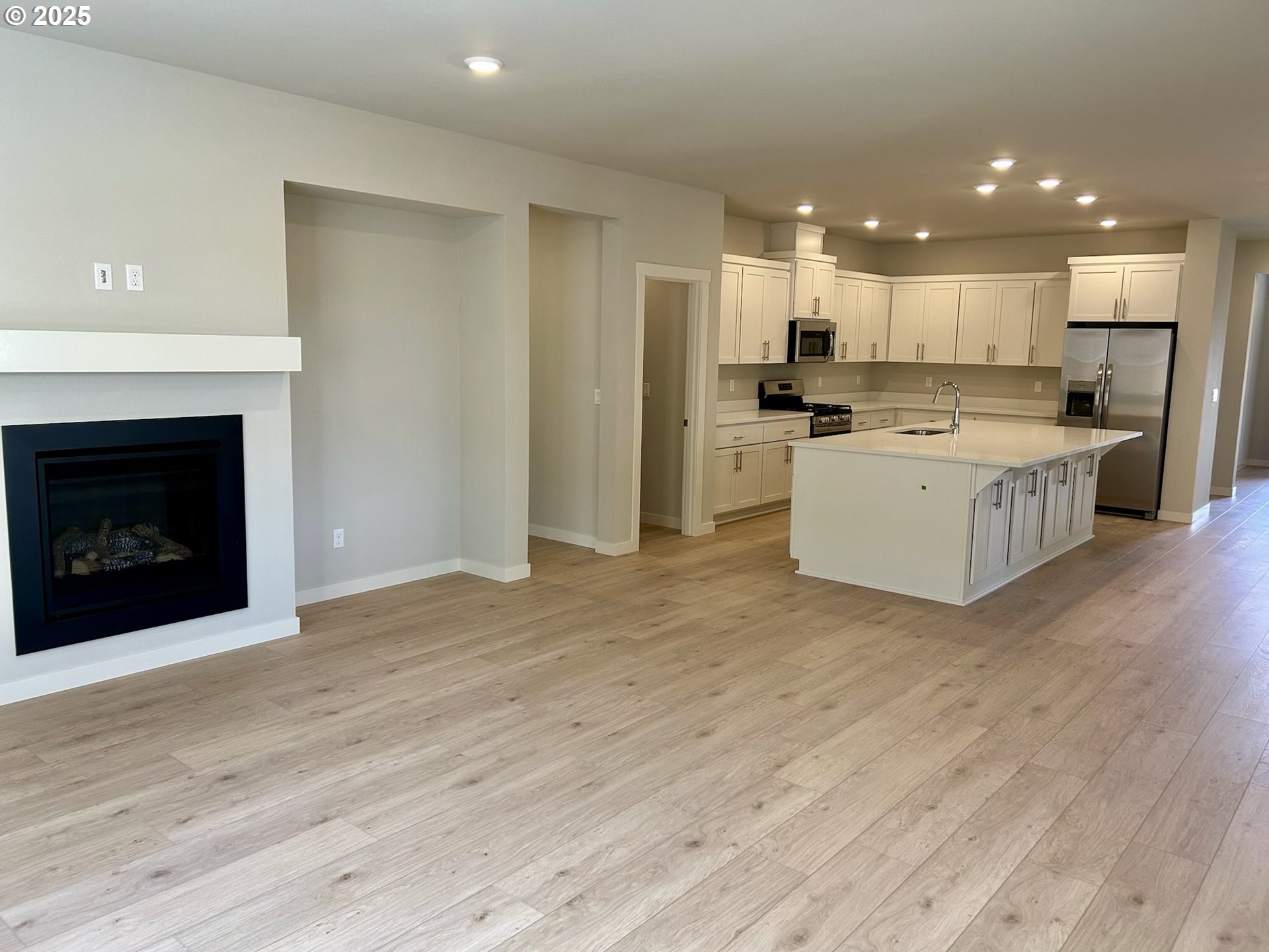 14956 Southwest 165th Avenue Tigard, OR 97224 - Photo 29 of 43 a view of kitchen with kitchen island wooden floor center island and stainless steel appliances