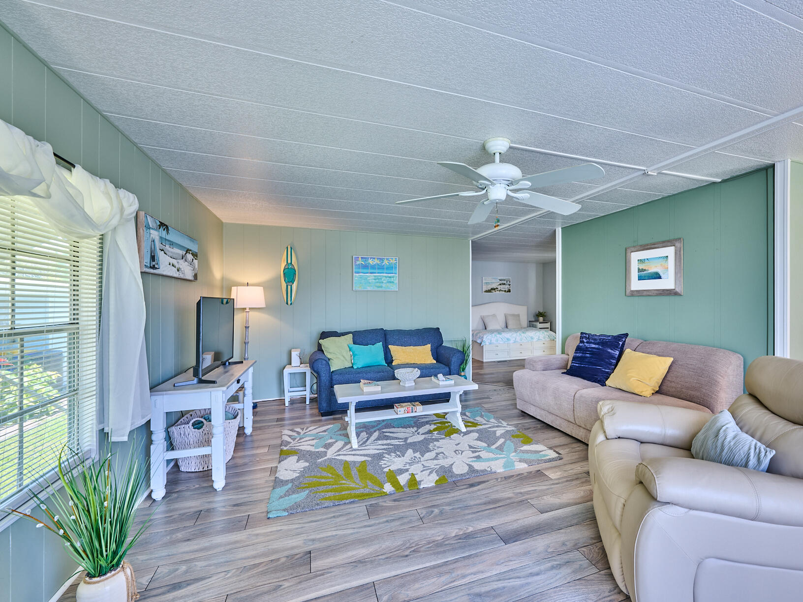 6977 Southeast Delegate Street Hobe Sound, FL 33455 - Photo 24 of 60 a living room with furniture and a wooden floor