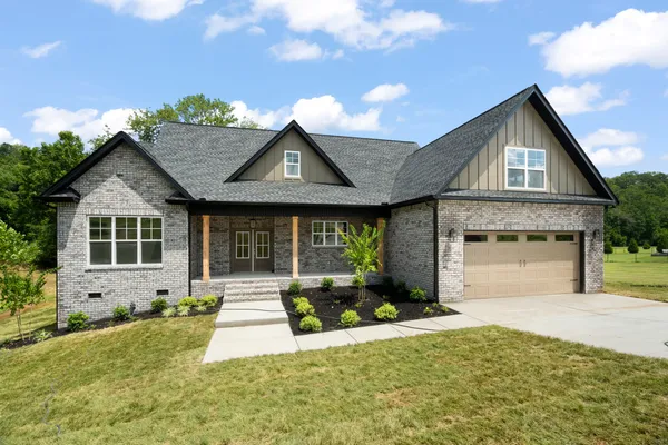 a front view of a house with a yard and garage