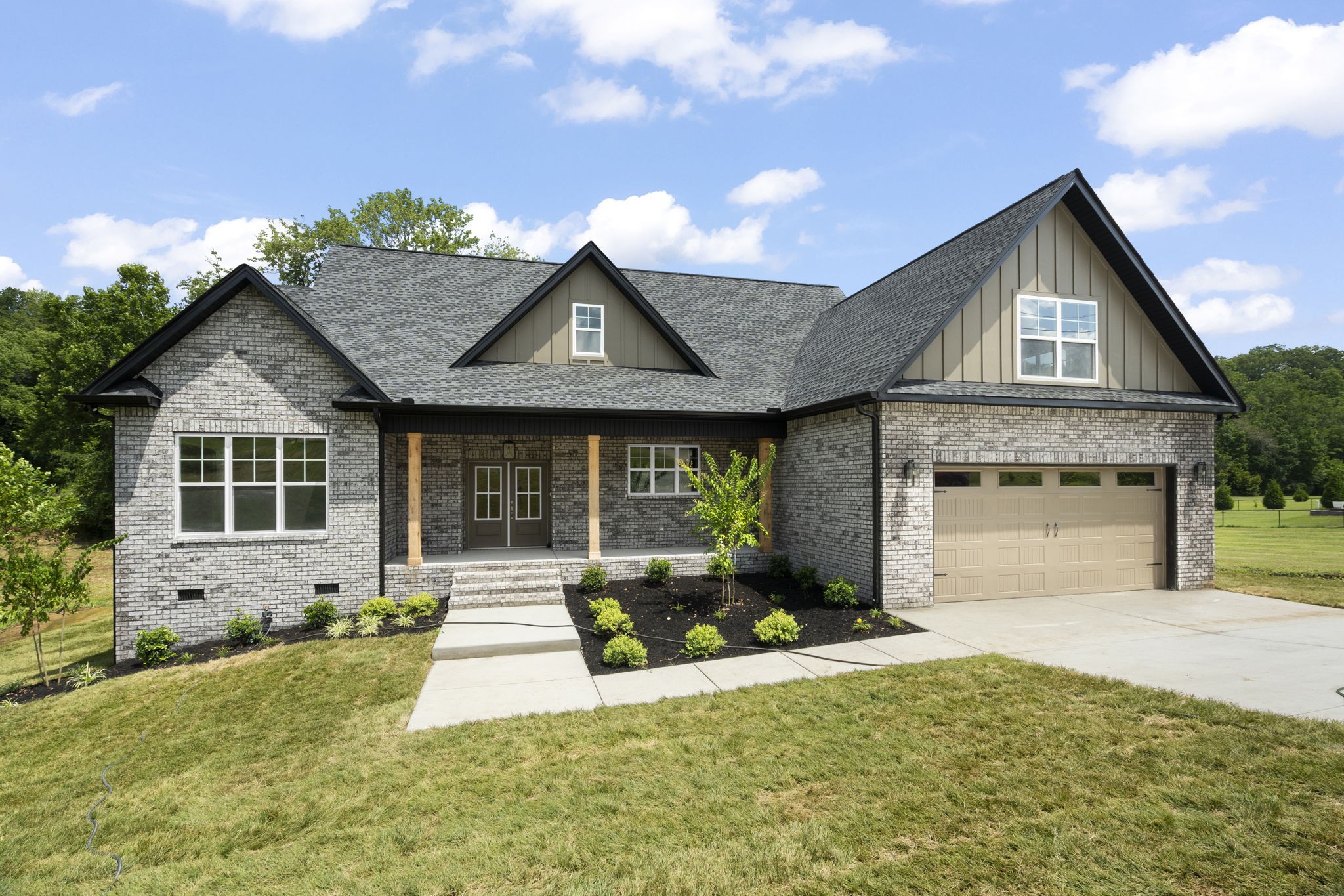 a front view of a house with a yard and garage