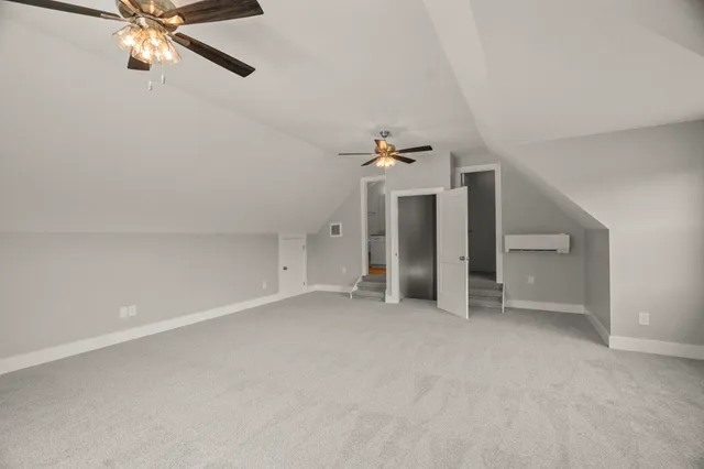 a view of an empty room with a ceiling fan