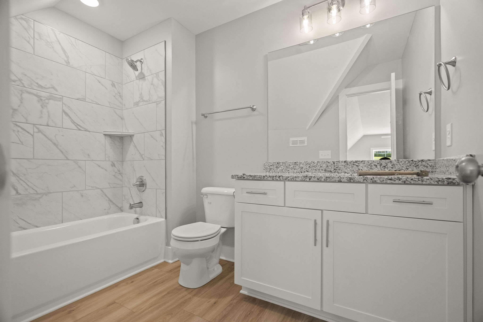 4062 Summit Drive Greenbrier, TN 37073 - Photo 28 of 36 a bathroom with a granite countertop sink toilet a mirror and bathtub