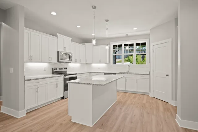 a kitchen with white cabinets and white appliances