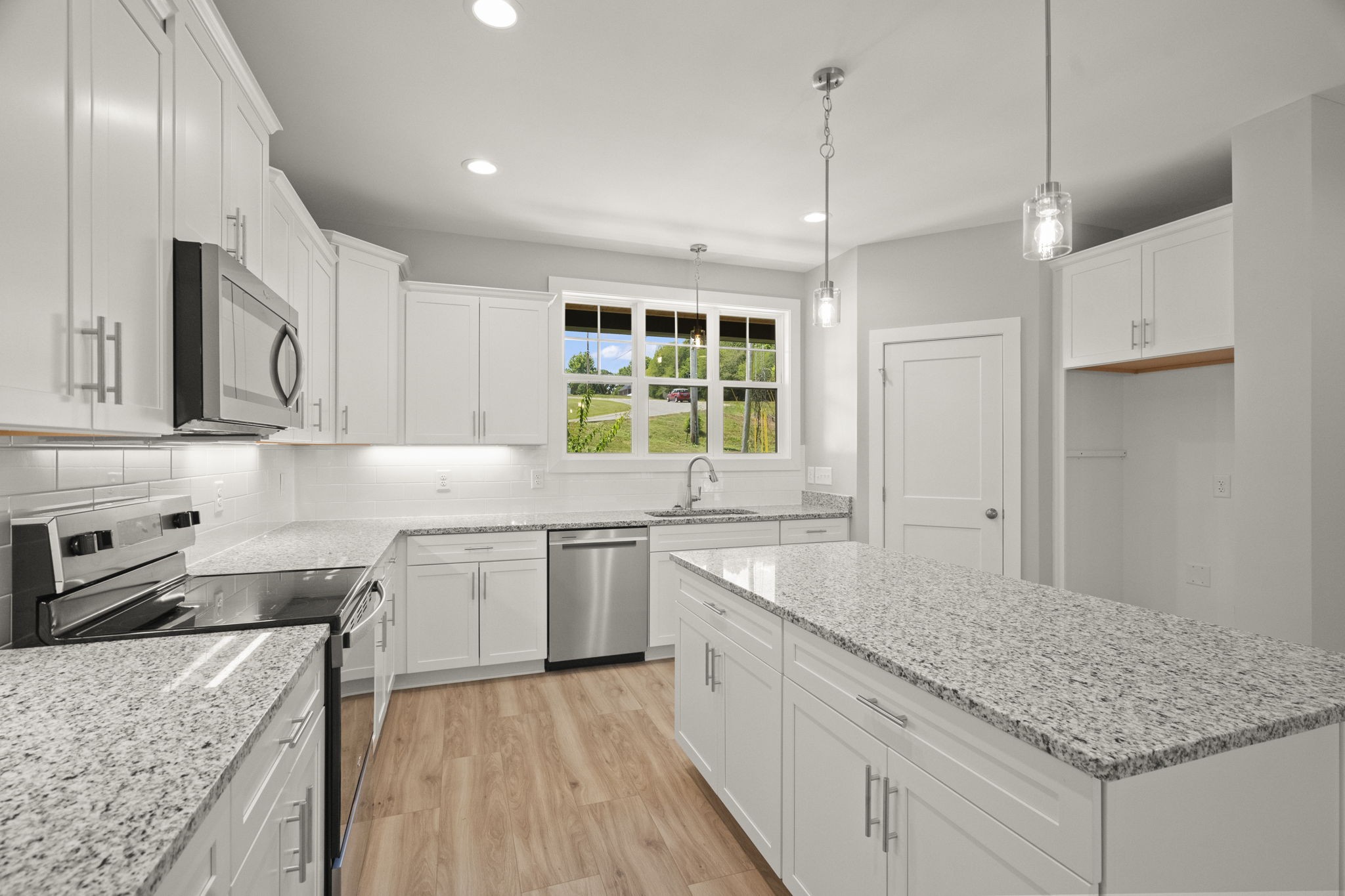 4062 Summit Drive Greenbrier, TN 37073 - Photo 9 of 36 a kitchen with stainless steel appliances granite countertop a sink stove and refrigerator