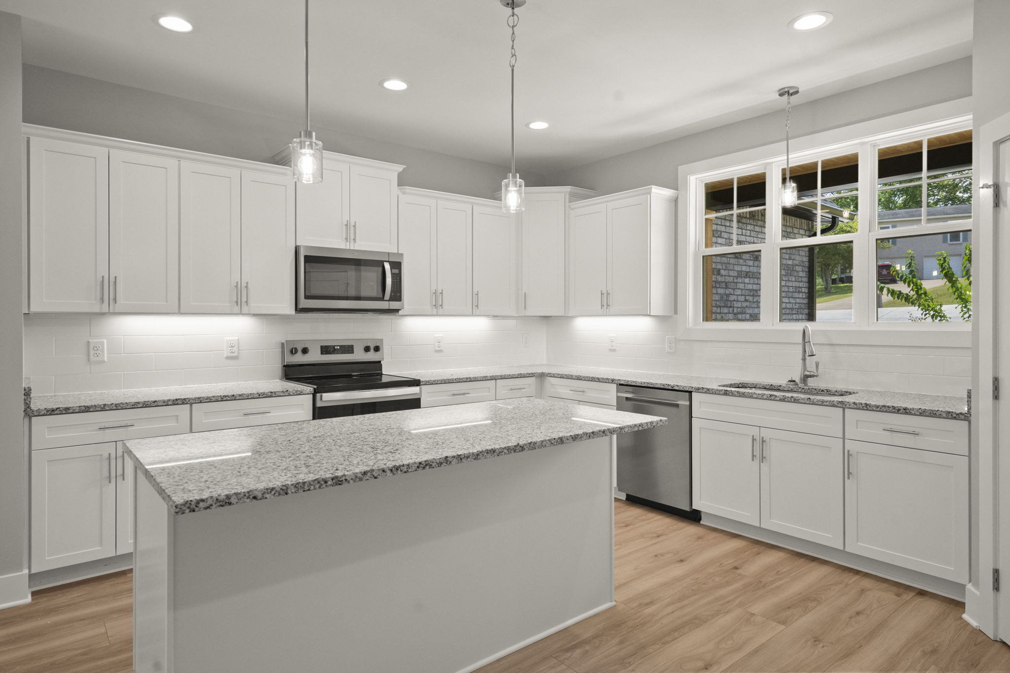 4062 Summit Drive Greenbrier, TN 37073 - Photo 10 of 36 a kitchen with stainless steel appliances granite countertop a sink a stove a microwave a center island and cabinets
