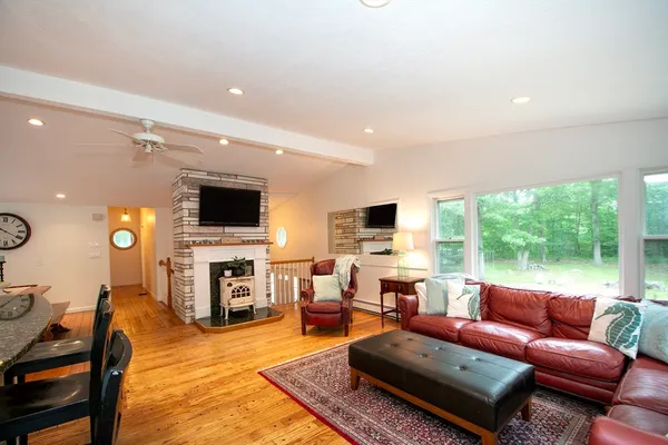 a living room with furniture a flat screen tv and a fireplace