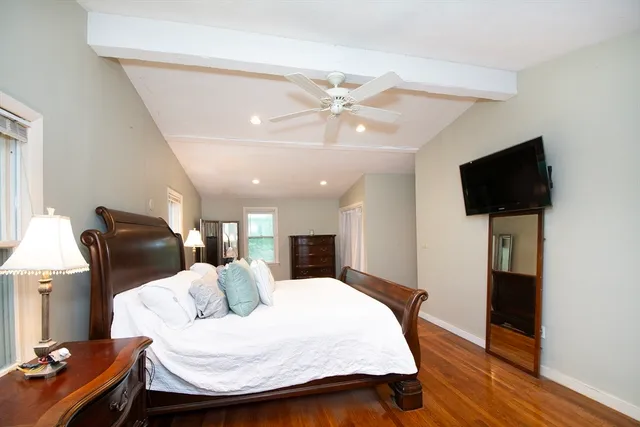 a bedroom with furniture and a flat screen tv
