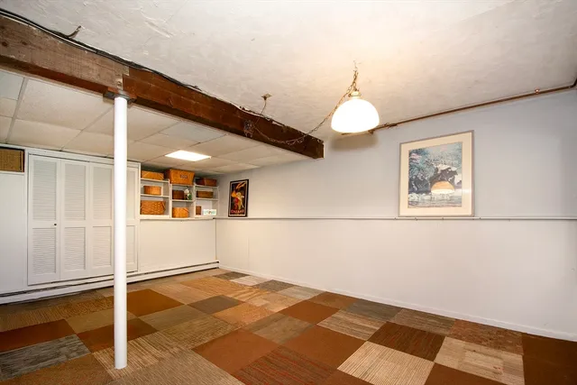 a view of a room with wooden floor and chandelier