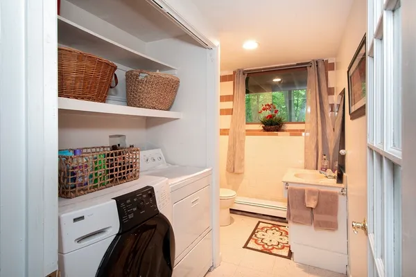 a room with a baby crib furniture and a window