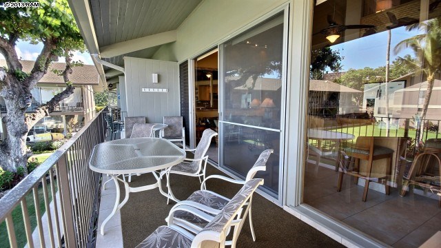 5255 Lower Honoapiilani Road, Unit 206 Lahaina, HI 96761 - Photo 25 of 30 a patio with a table and chairs and potted plants