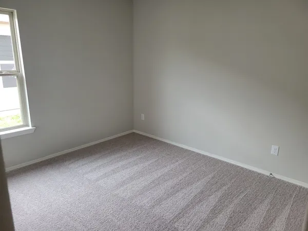 a view of an empty room and a window