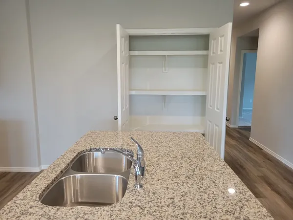a kitchen with a sink and natural light