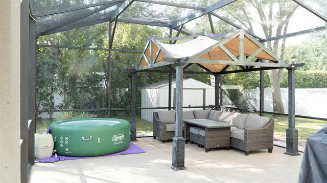 a view of a patio with a table chairs and a backyard