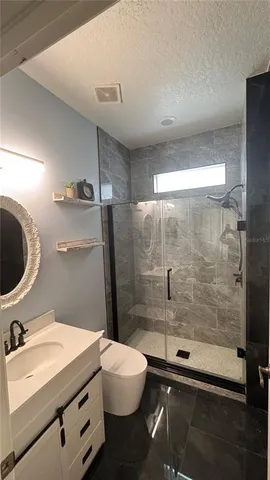 a bathroom with a sink a toilet and a shower