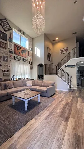 a living room with fireplace furniture and a wooden floor