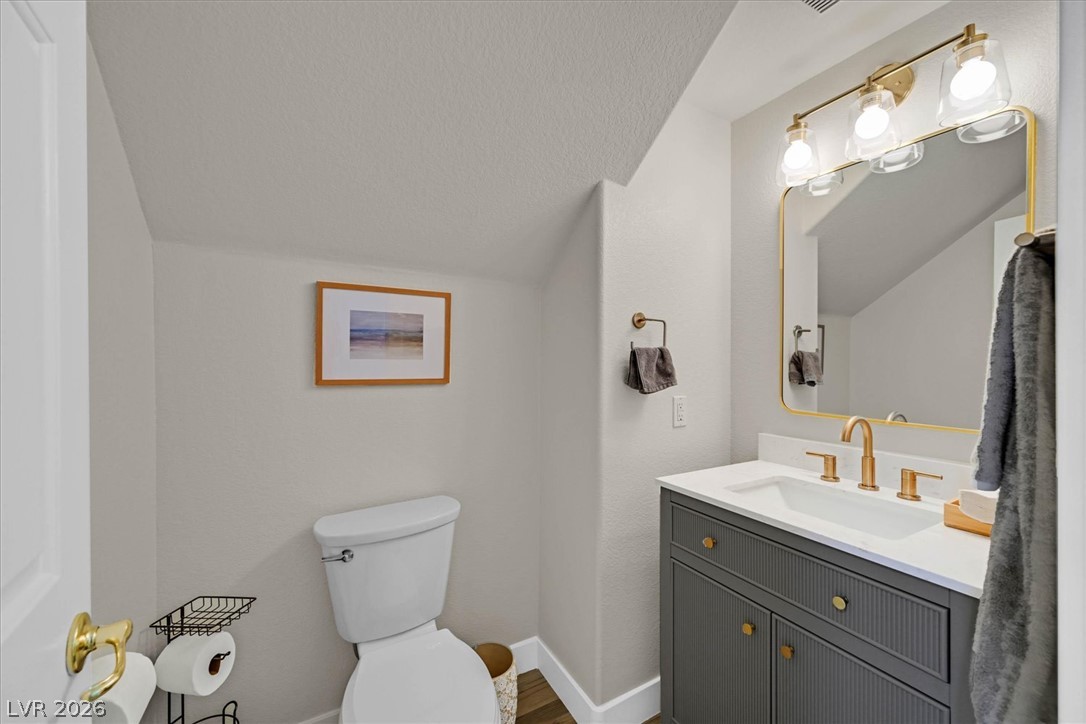 1259 Moon Vision Street Henderson, NV 89052 - Photo 13 of 53 A well-appointed half bath features a stylish vanity and modern fixtures.